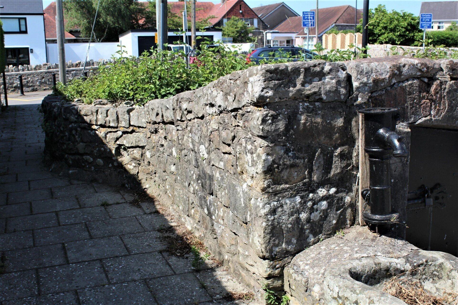 Laleston ancient village well — stone walls and metal pump, top of Well Street